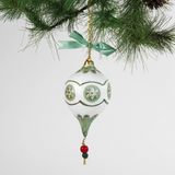 paper mache green star christmas ornament hanging in a branch
