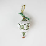 paper mache green star christmas ornament on a white background