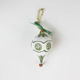 paper mache green star christmas ornament on a white background