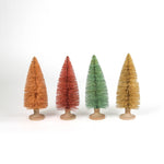Four miniature bottle brush Christmas trees table decorations in light pink, pink, green and beige on a white background.