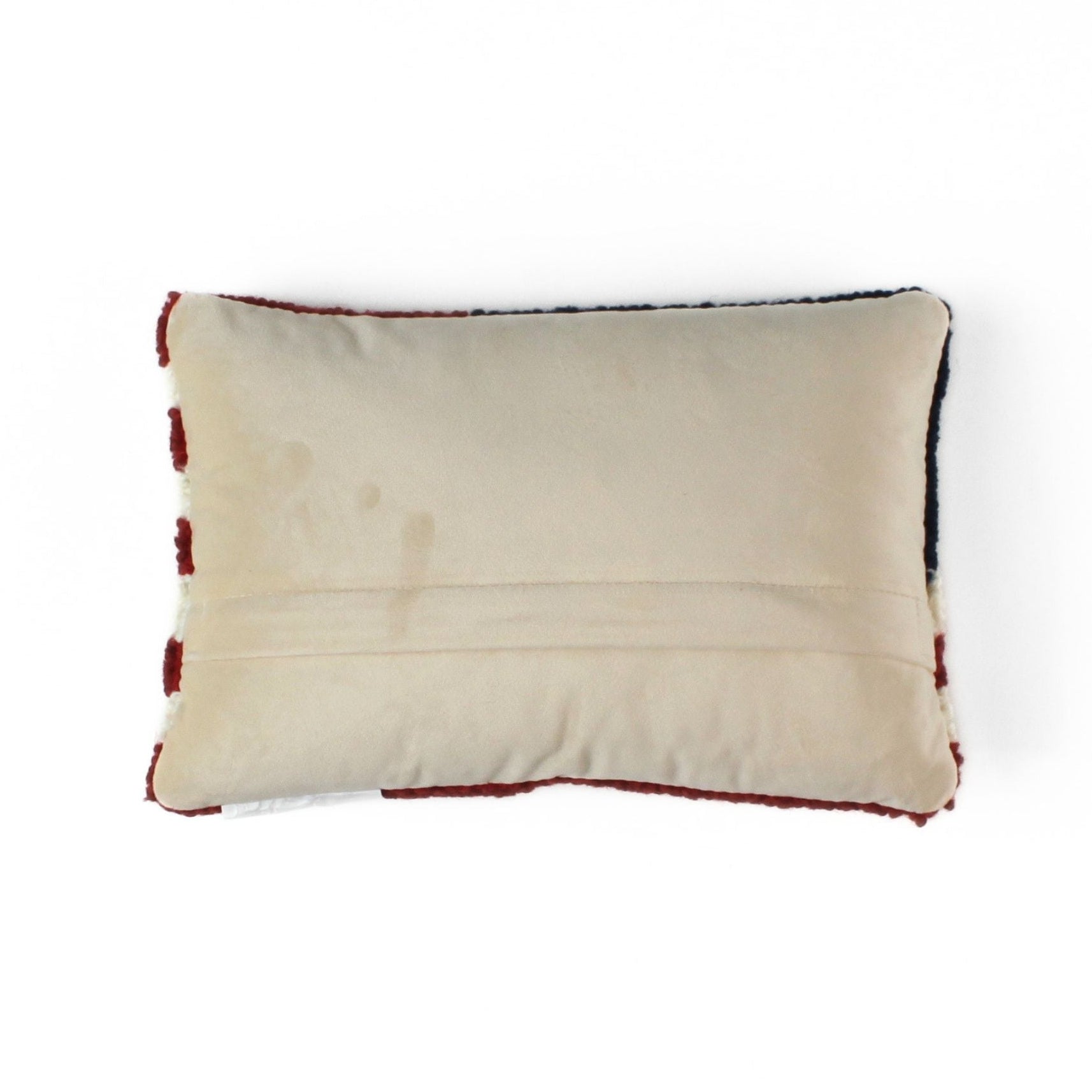 Patriotic USA flag red white blue pillow back view with solid fabric backing and stitched seam detail.