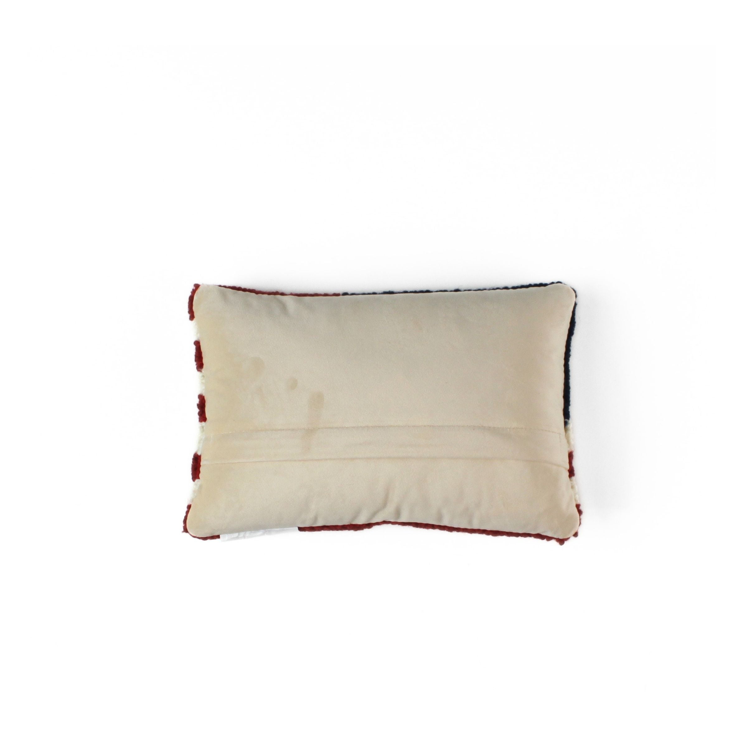 Patriotic USA flag red white blue pillow back view with solid fabric backing and stitched seam detail.