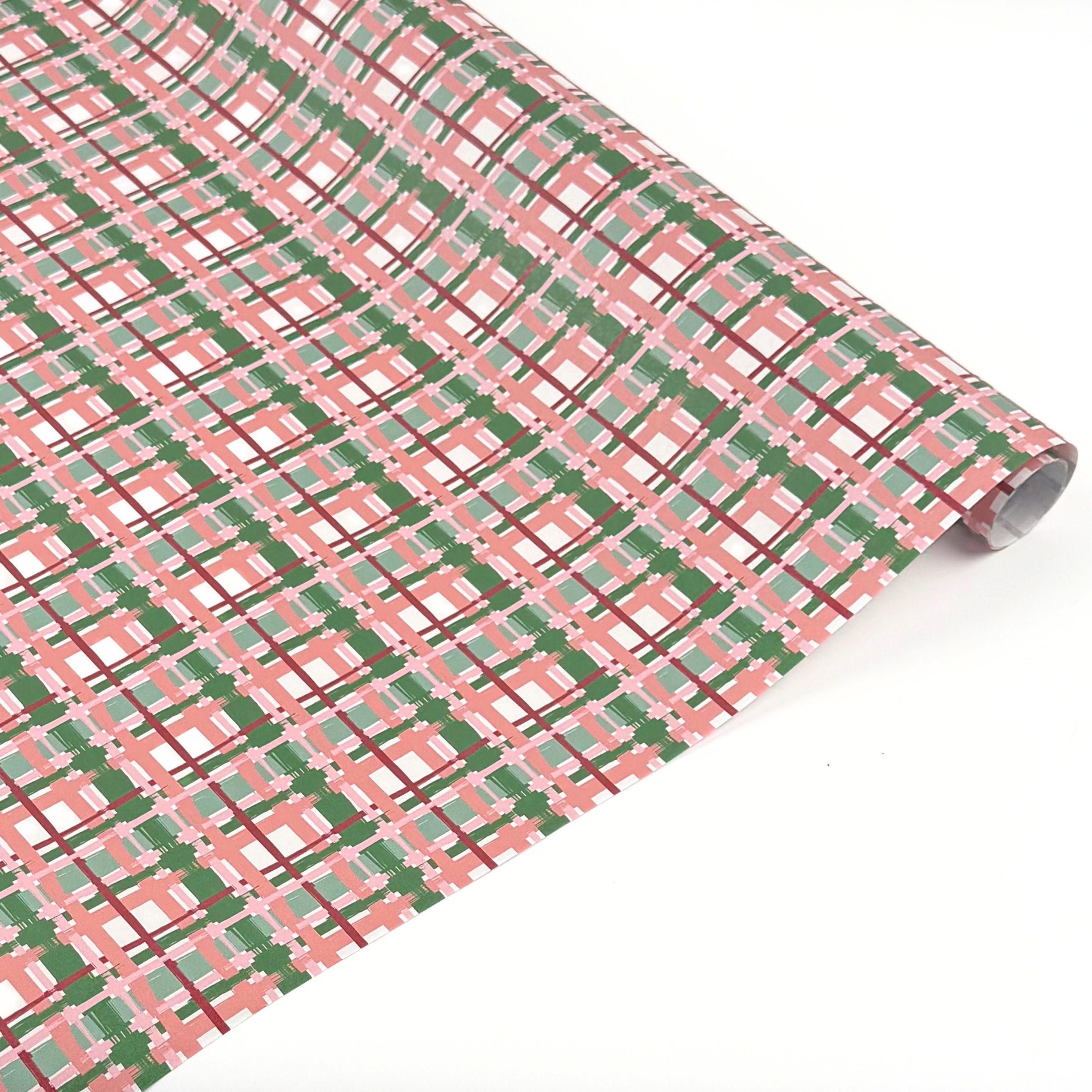 Charming gift wrap featuring peach, green, and pink plaid patterns, perfect for beautifully wrapped presents.