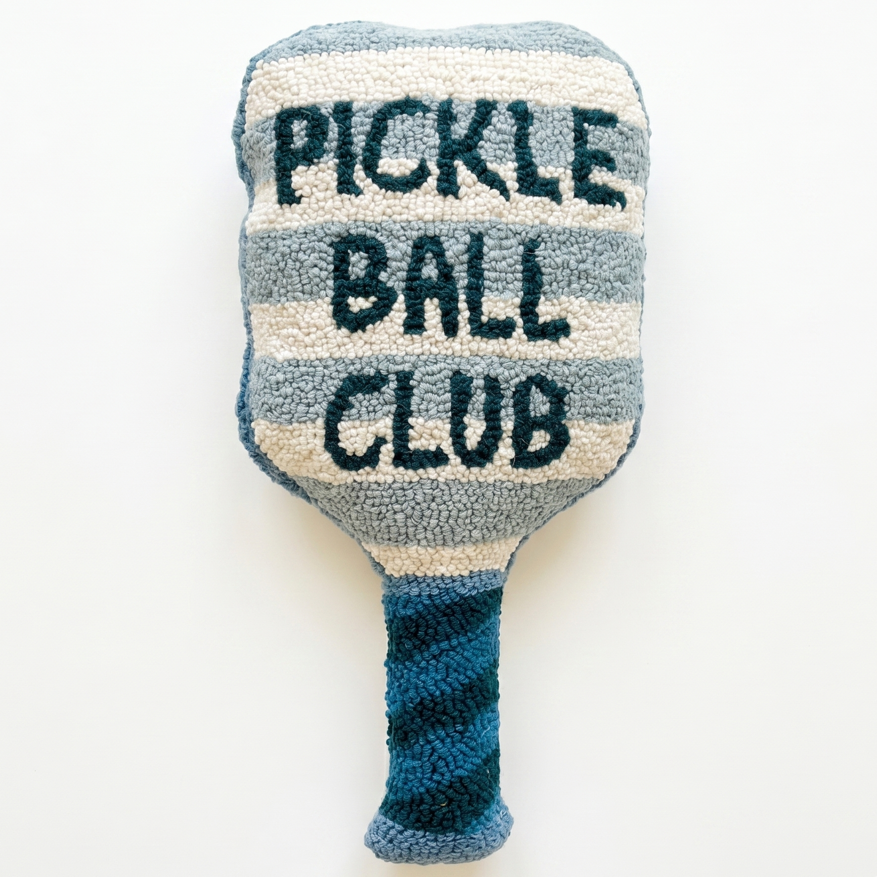 a pickleball paddle shaped pillow that is striped with navy blue text that reads pickle ball club 