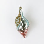 Decorative glass ornament with a spiral design on a white background