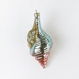 Decorative glass ornament with a spiral design on a white background