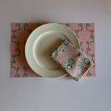 pink bamboo lattice paper placemat with white plate top view table setting