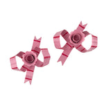 top view of pink bow shaped candle holders with glossy finish on white background