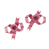 top view of pink bow shaped candle holders with glossy finish on white background