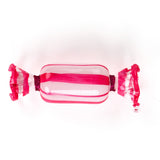 a pink glass candy ornament on a white background