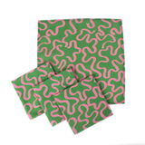 Set of green napkins with playful pink squiggle pattern arranged on a white background, modern table linens perfect for Christmas tea towel styling, holiday entertaining, and seasonal home décor