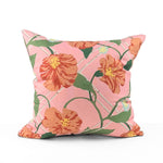 Pink tropical outdoor pillow with bold floral and botanical design.