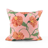 Pink tropical outdoor pillow with bold floral and botanical design.