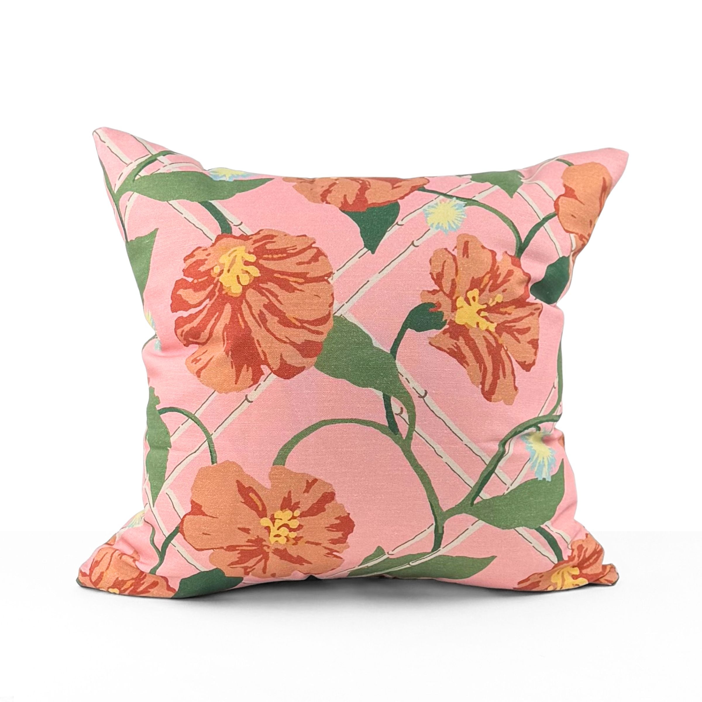 Pink tropical outdoor pillow with bold floral and botanical design.