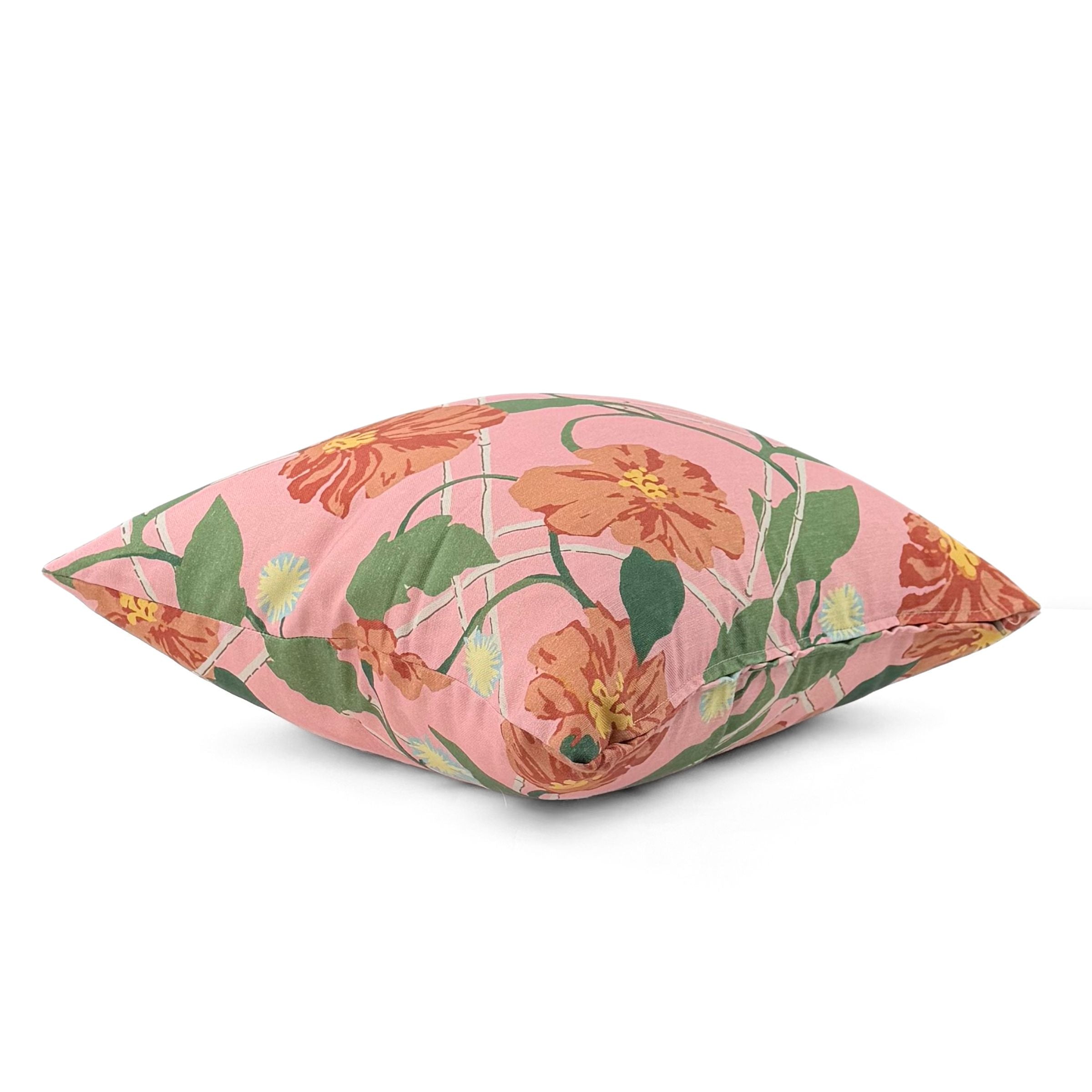 Pink tropical outdoor pillow with vibrant floral pattern.