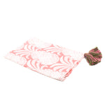 a white and pink pineapple tea towel with pink and green tassels against a white background. 