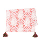a white and pink pineapple tea towel with pink and green tassels against a white background. 
