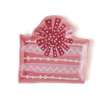 a pink christmas accent plate in the shape of a christmas gift. 