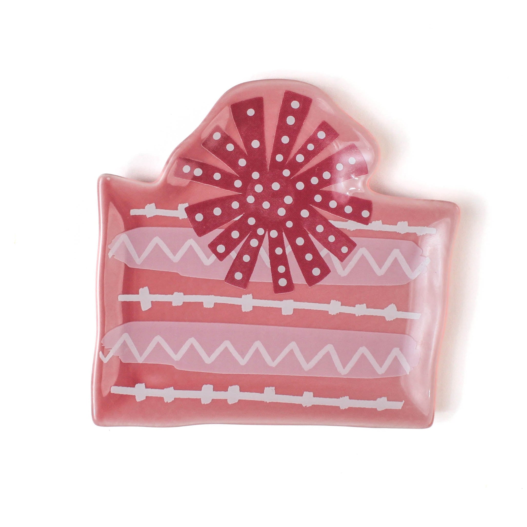 a pink christmas accent plate in the shape of a christmas gift. 