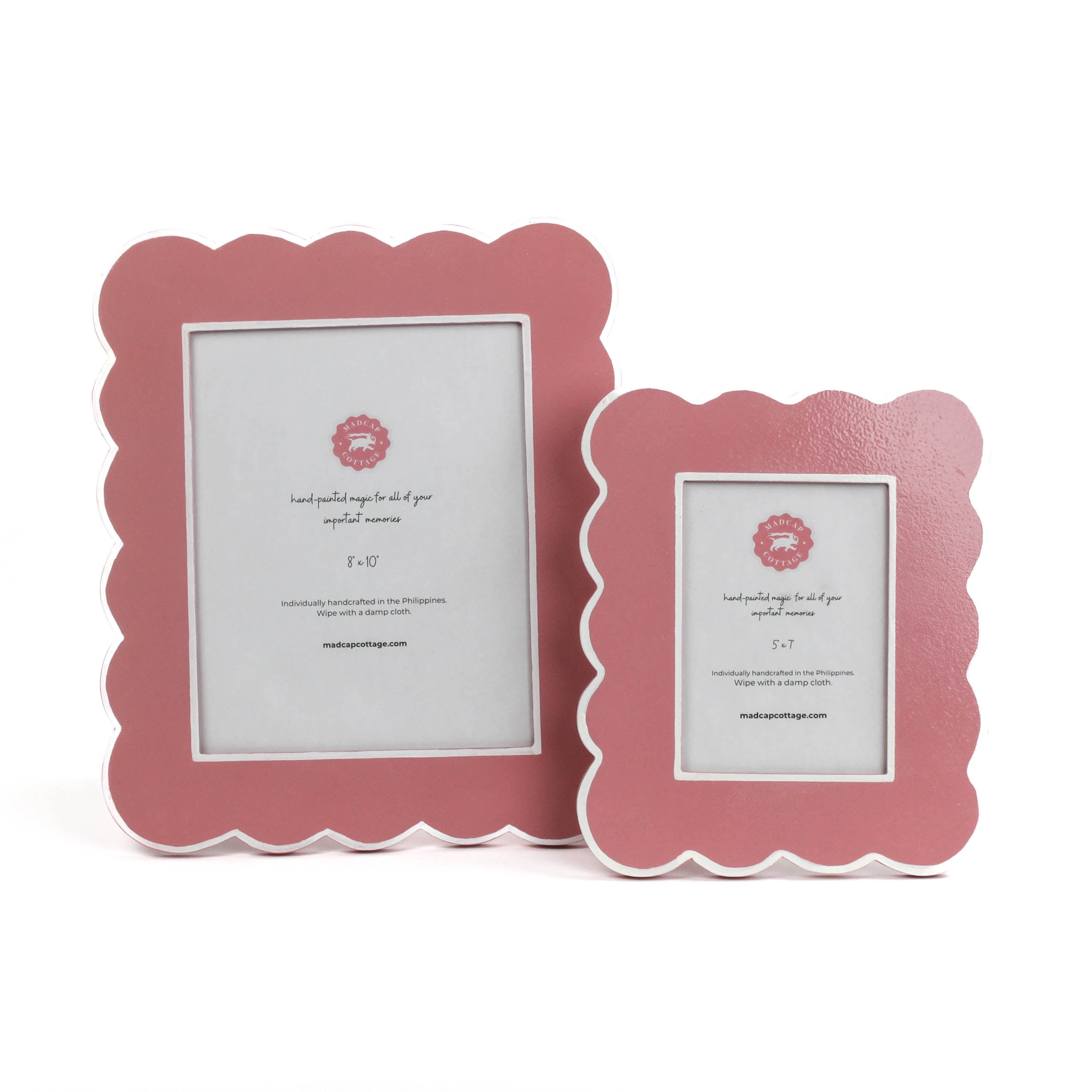 Two pink scalloped photo frames on a white background