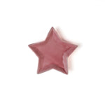 Pink star-shaped object on a white background