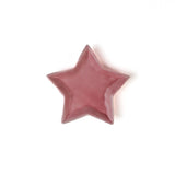 Pink star-shaped object on a white background