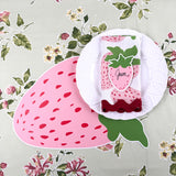 strawberry die-cut paper placemat spring table setting with white plate and strawberry napkin.