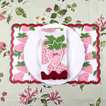strawberry paper placemat spring table setting with white plate and strawberry napkin.