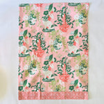 a pink chinoiserie tea towel from madcap cottage with pug and vase motifs.
