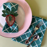 bahama court green dinner napkins from madcap cottage resting on a pink dinner plate