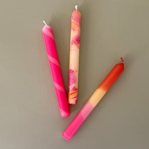 three pink assorted taper candles