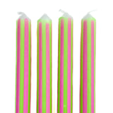 Green and pink pinstripe taper candles set with colorful vertical stripes for spring table decor.