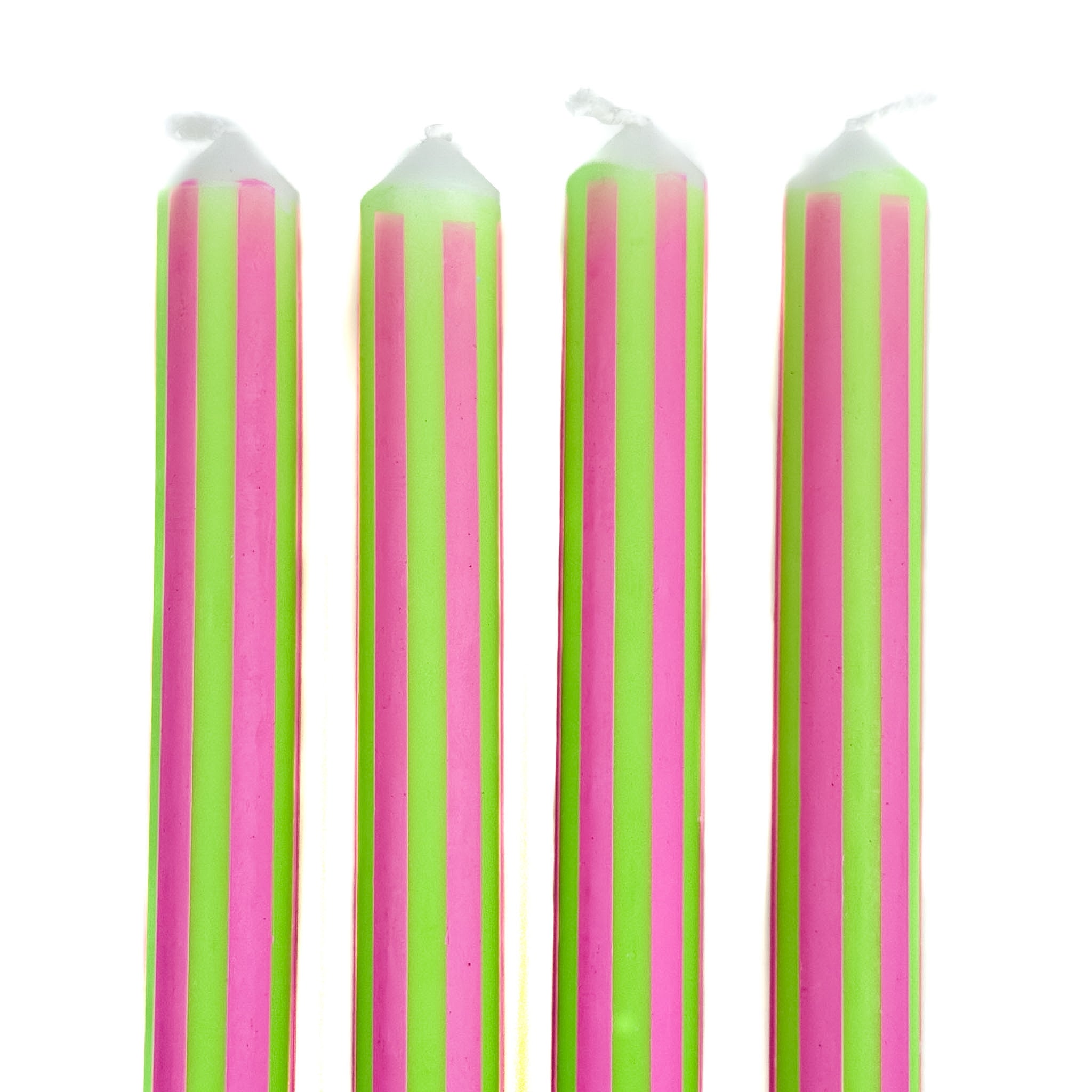 Green and pink pinstripe taper candles set with colorful vertical stripes for spring table decor.