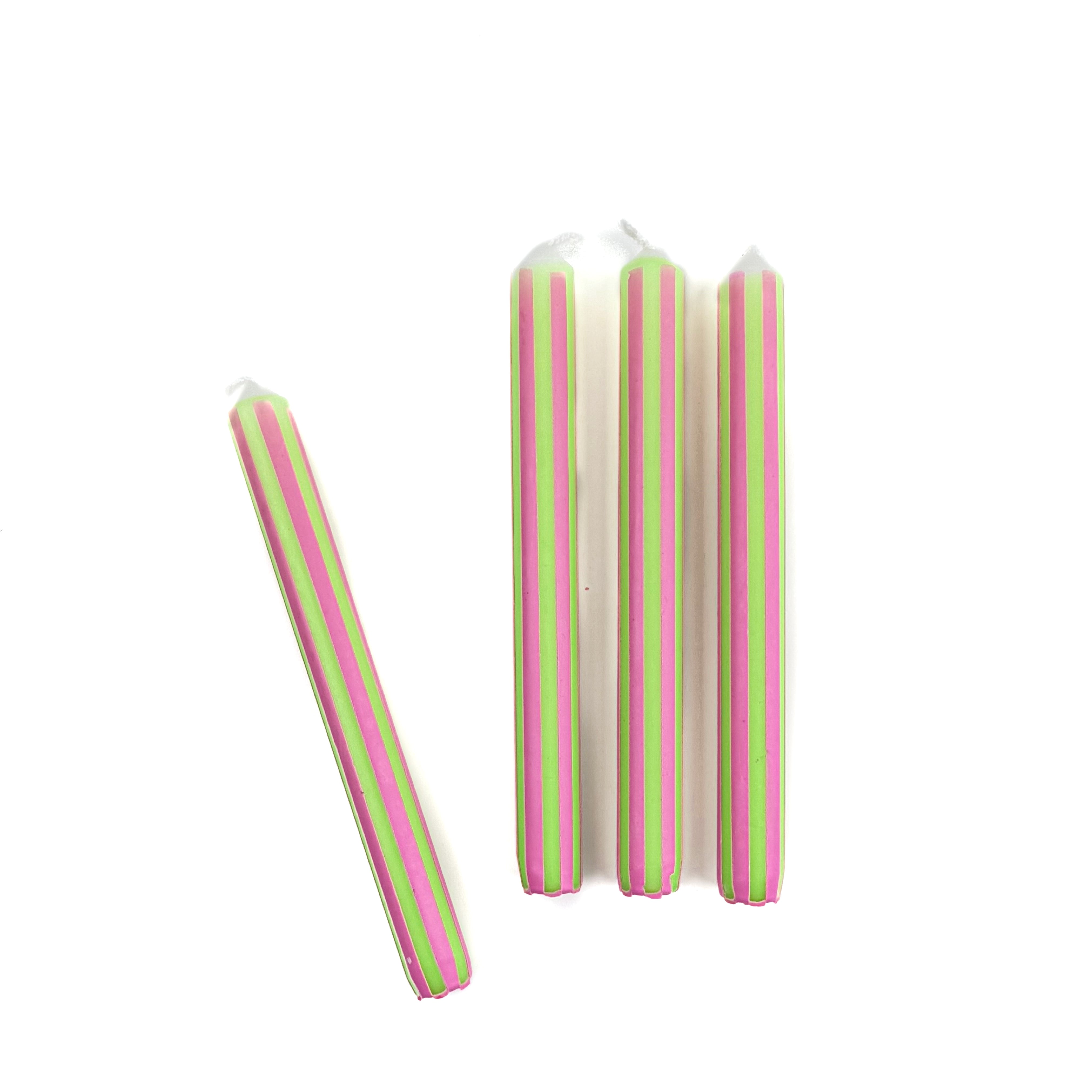 Green and pink pinstripe taper candles set with colorful vertical stripes for spring table decor.