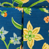 Blue floral upholstered loveseat with botanical pattern and rolled arms
