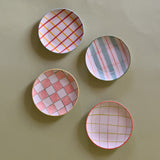 four assorted pattern plaid accent plates