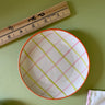 pink and green plaid ceramic plate with ruler for size reference