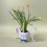 white rattan bunny easter basket with plant in it