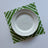 White and green paper placemats featuring a white bamboo pattern called Island House by Madcap Cottage