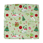 a green christmas napkin with pugs, christmas trees and candy cane motifs on a white background
