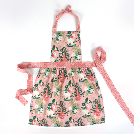 Madcap Cottage Floral apron with pink and green design on a white background