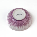 bottom view of a purple flower shaped bowl on a white background