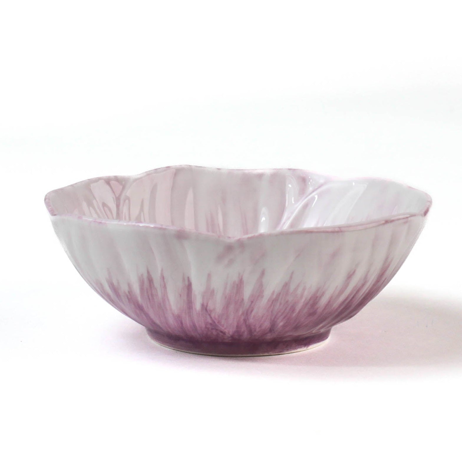 side of a purple flower shaped bowl on a white background