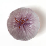 top view of a purple flower shaped bowl on a white background