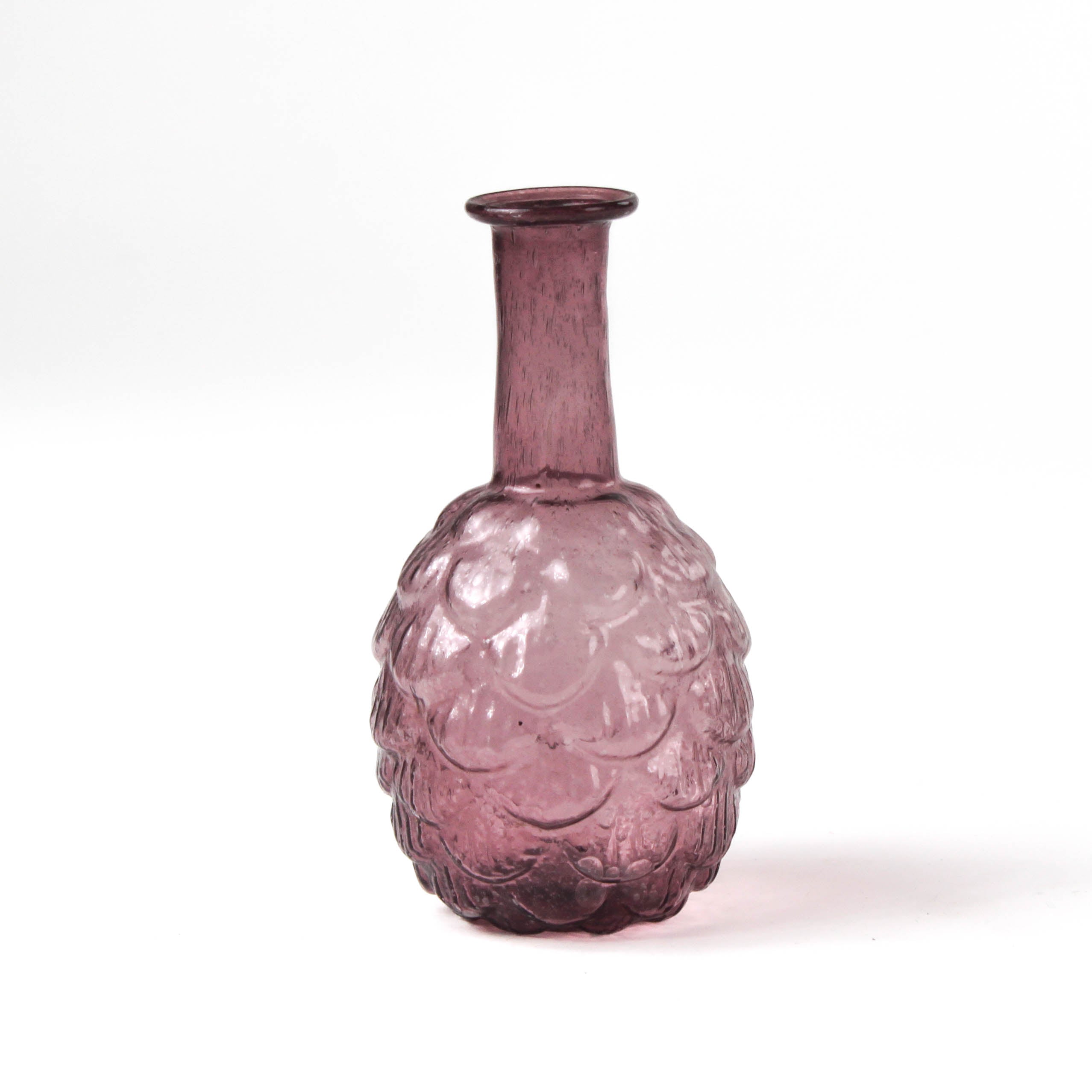 Pink glass vase with textured surface on a white background
