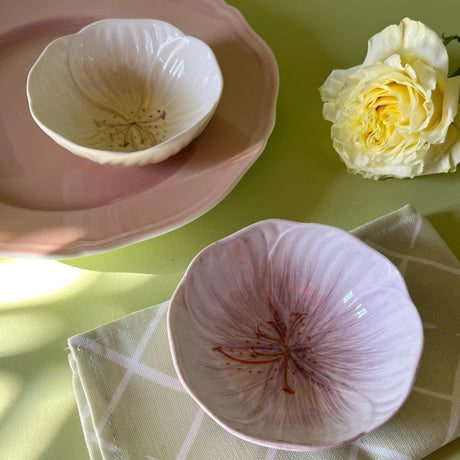 purple and yellow flower shaped bowls on a table