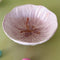 purple flower shaped bowl on a green background