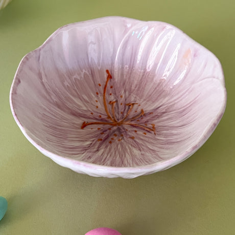 purple flower shaped bowl on a green background