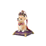 corgi christmas ornament with a crown and Union Jack bow tie on a purple cushion.