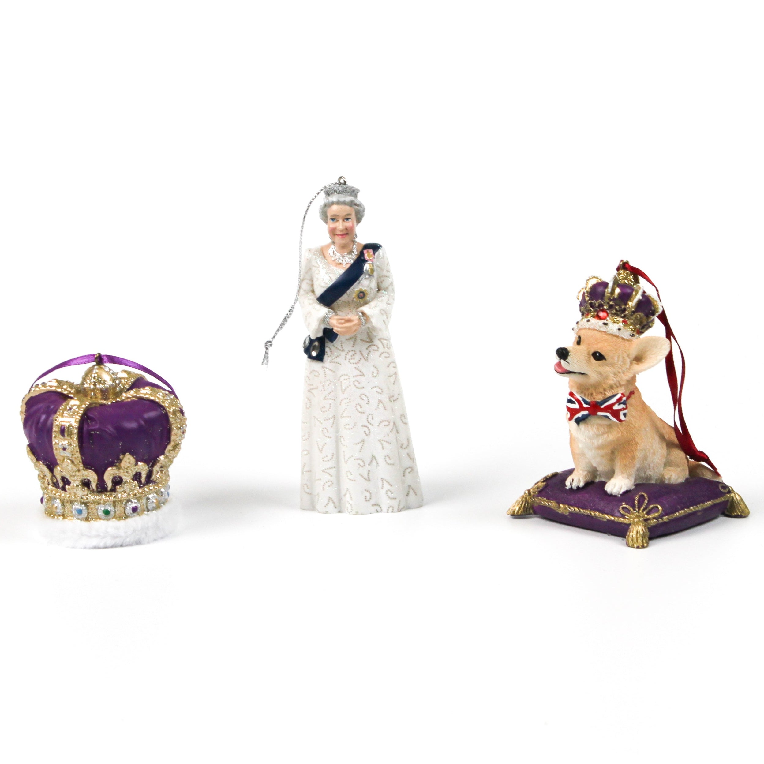 an queen elizabeth ornament, a purple crown ornament and a corgi ornament photographed on a white background.